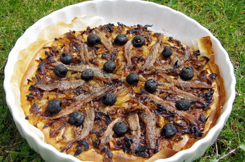 Traditional Niçoise pissaladière with anchovies, onions, and olives