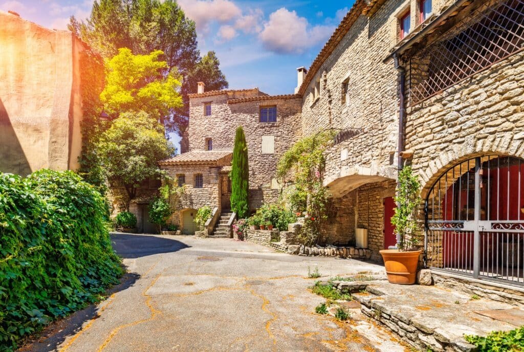Sunlit narrow street in the village of Goult in Provence