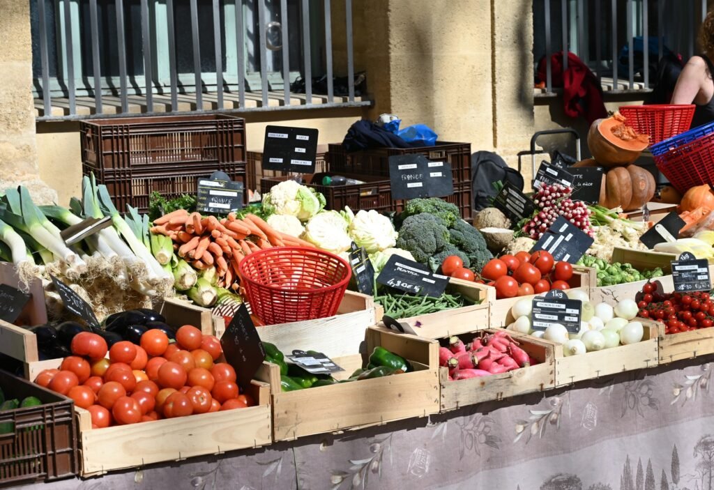 Seasonal fruit and vegetable stall at the Aix-en-Provence market in spring, featuring fresh local produce from Provence